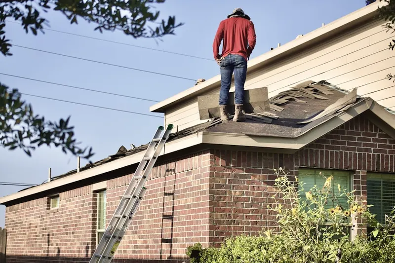 Professional roofer working on a residential roof in Highlands of McKamy